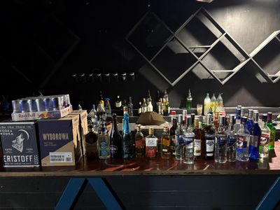 de nombreuses bouteilles d'alcool posées sur une table dans un bar