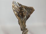 a bronze statue of a woman holding a flower