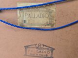 a label on a piece of paper that is tied to a string