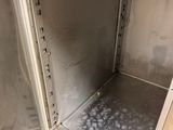 a metal cabinet with a door open on a wooden floor