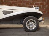 an image of a white car parked in front of a brick wall