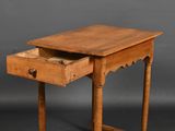 an old wooden table with a drawer on top of it