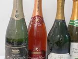 several bottles of wine are lined up on a white surface