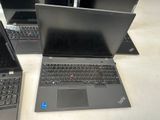three laptops are sitting on a table with their lids open