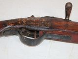 an old wooden rifle with a wooden handle on a white surface