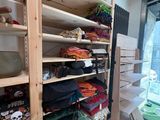 a closet with a lot of clothes on the shelves