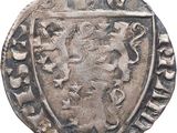 Gros plan sur une pièce de monnaie portant des armoiries