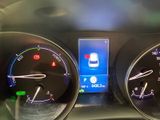 a car dashboard with a clock and a cell phone on it