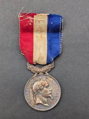 a medal with a red, white and blue ribbon on it