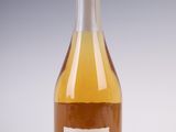 a bottle of wine sitting on top of a table next to a glass