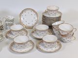 many cups and saucers that are sitting on a table