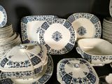 a lot of blue and white plates and bowls on the table
