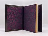 two open book covers with floral designs on them on a white surface