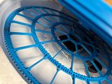 a close up of a blue wheel on a blue and white vehicle
