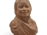 an image of a clay bust of a woman wearing a headscarf