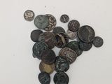 some old coins are scattered on a white surface