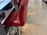 two red chairs that are sitting in front of a counter