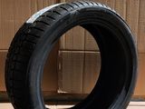 tire on the floor next to cardboard boxes in a warehouse