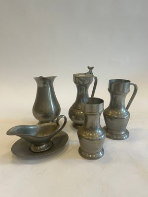four pieces of silverware sitting on top of a white table