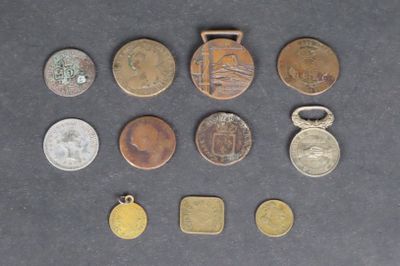 several different coins are arranged in a row on a table