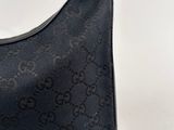 a close up of a black guccissi bag on a white background