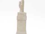 marble statue of a hand holding a finger on a pedestal