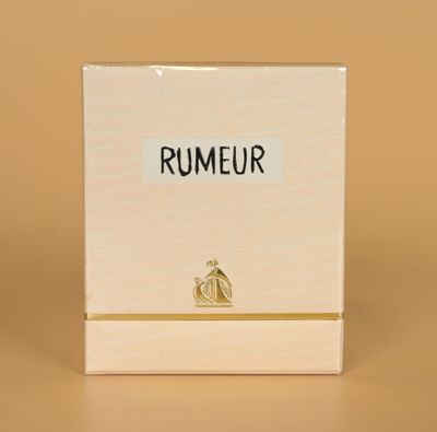a close up of a box of perfume sitting on a table