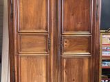 an image of a wooden armoire with a mirror on top of it