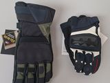 pair of black and green motorcycle gloves on a white surface