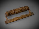 an old wooden toilet roll holder with carvings on it