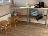 une petite table avec deux tabourets devant une fenêtre