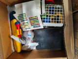 a cardboard box with a bunch of toys inside of it