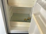 an open refrigerator with a small amount of food inside of it