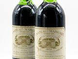 two bottles of wine sitting next to each other on a table