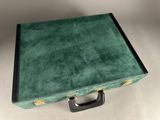 a green suitcase that is sitting on a table