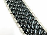 an image of a close up of a black and white bracelet