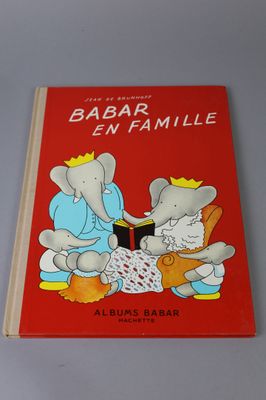 a red book with a picture of an elephant and an elephant reading a book