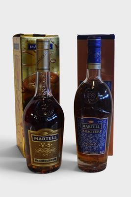 two bottles of liquor sitting next to each other in front of a box