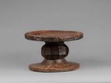 an image of a small wooden table with a wooden base