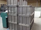 a large stack of metal crates in a warehouse