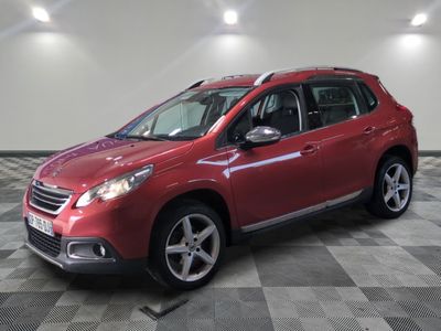 the red car is parked on a checkered floor in the garage
