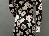 an image of a mannequin wearing a black and white dress with playing cards on it