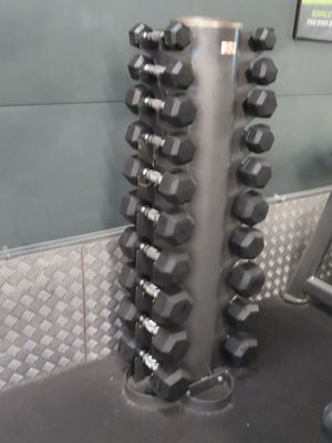 a rack of dumbbells in a gym room