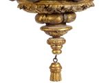 a gold clock hanging from the ceiling of a room
