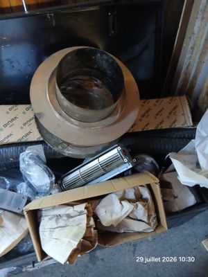 a toilet that is sitting next to a pile of other items