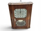 a wooden clock that is sitting on a white surface