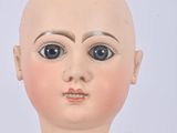 a close up of a doll with a bald head