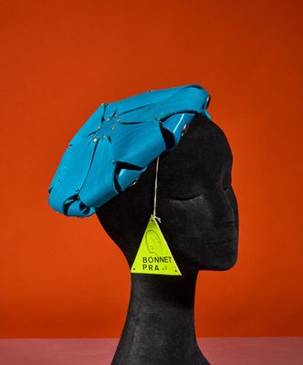 a close up of a mannequin head with a blue hat on it