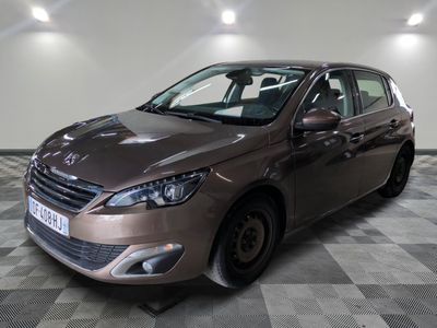 the brown car is parked on a checkered floor in the garage