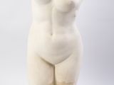 marble sculpture of a female nude torso on a marble base